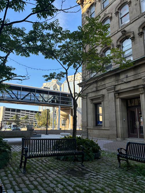 A modern building and plaza with people in front